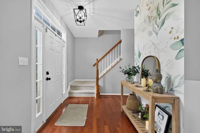 a living room with furniture fireplace and chandelier