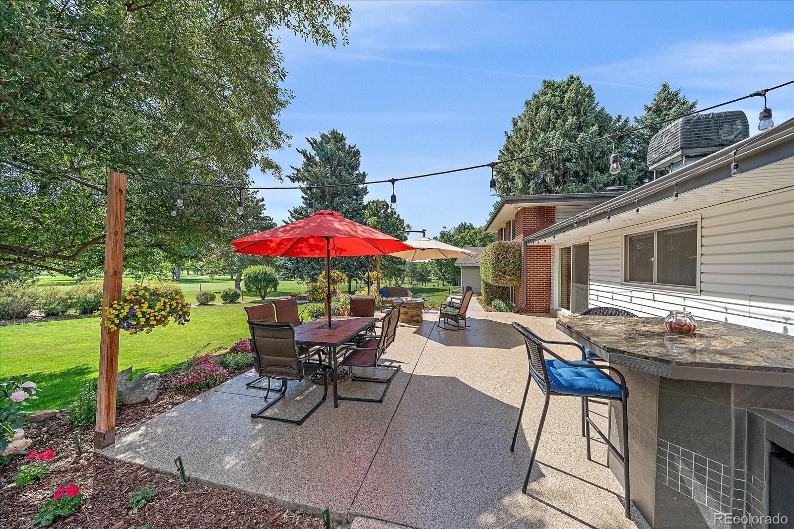 930 Reed Court Lakewood, CO 80214 - Photo 35 of 41 a view of a patio with a table and chairs under an umbrella