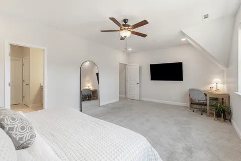 a bedroom with a bed and a flat screen tv