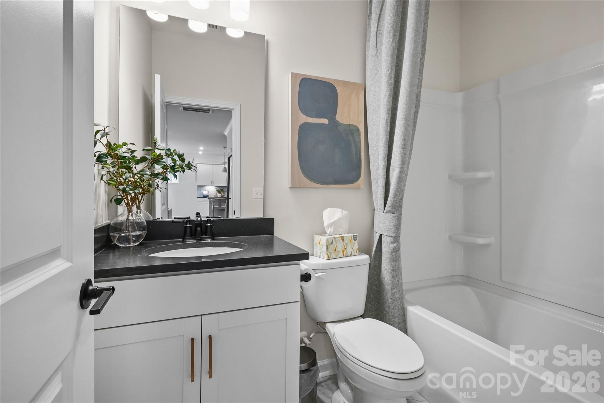 2149 Riverbend Avenue Monroe, NC 28110 - Photo 11 of 22 a bathroom with a granite countertop sink a toilet a mirror and bathtub