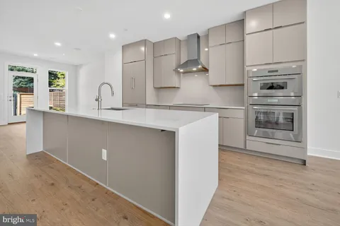 a kitchen with stainless steel appliances a sink stove and refrigerator