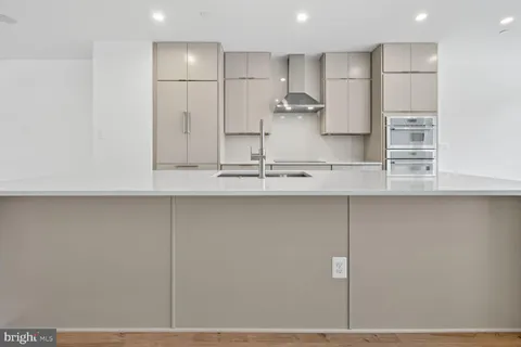a kitchen with kitchen island cabinets and stainless steel appliances