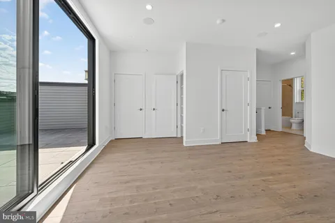 a view of a hallway with wooden floor and a fireplace
