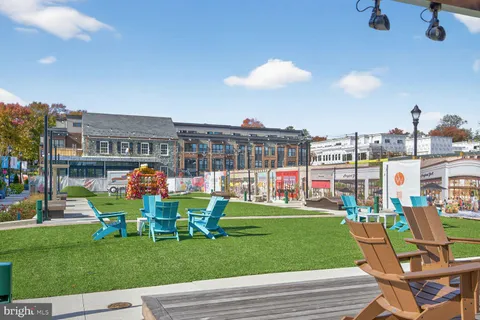 a view of a building with a garden and pathway