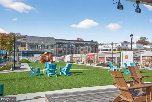 a view of a building with a garden and pathway