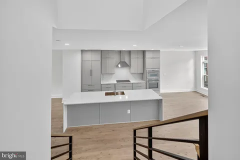 a view of kitchen with counter top space and windows