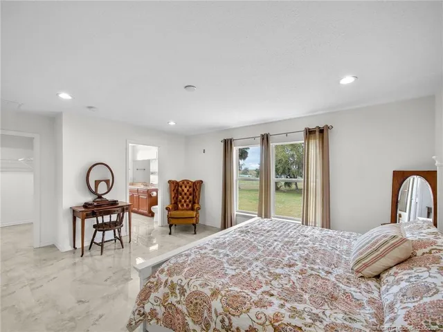 a bedroom with a large bed and a large window
