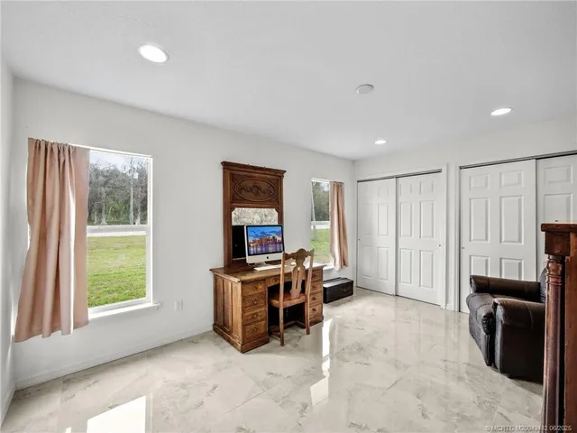 a view of work space with furniture and a window