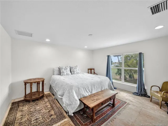 a bed room with a bed and a chair