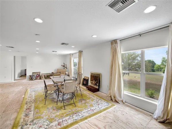 a view of a dining room with furniture window and outside view