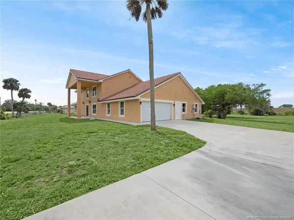 a front view of a house with yard and garage