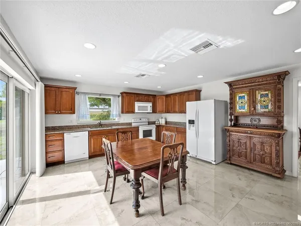 a dining room with furniture and window