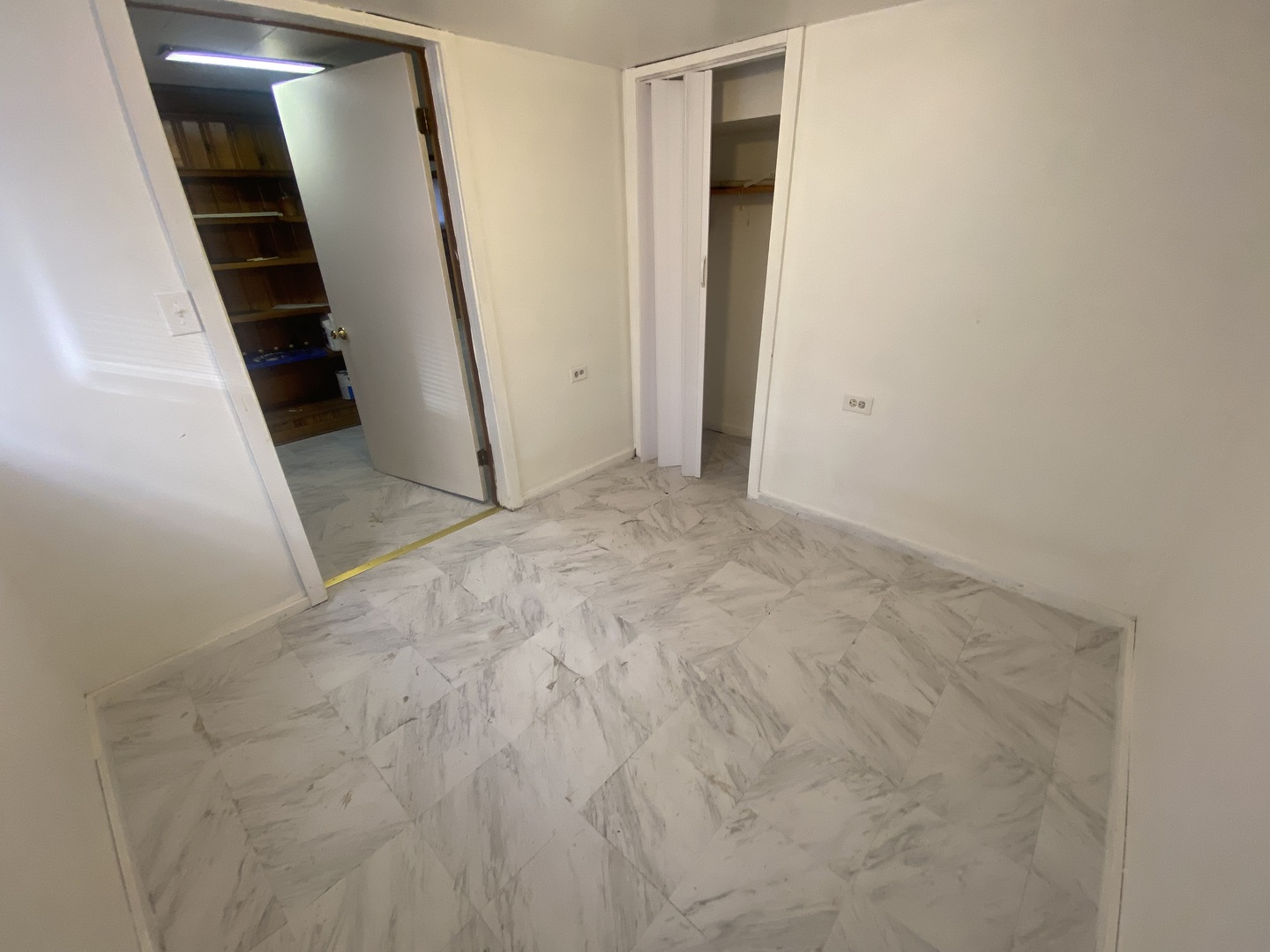 5514 North Mango Avenue, Unit G Chicago, IL 60630 - Photo 5 of 9 an empty room with staircase and white walls