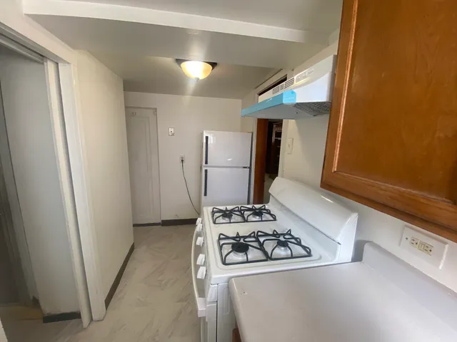 a kitchen with a stove and a refrigerator