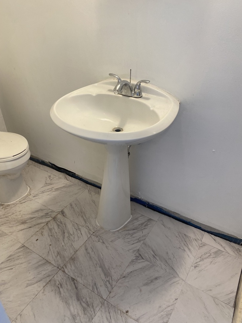 5514 North Mango Avenue, Unit G Chicago, IL 60630 - Photo 7 of 9 a bathroom with a sink and a toilet