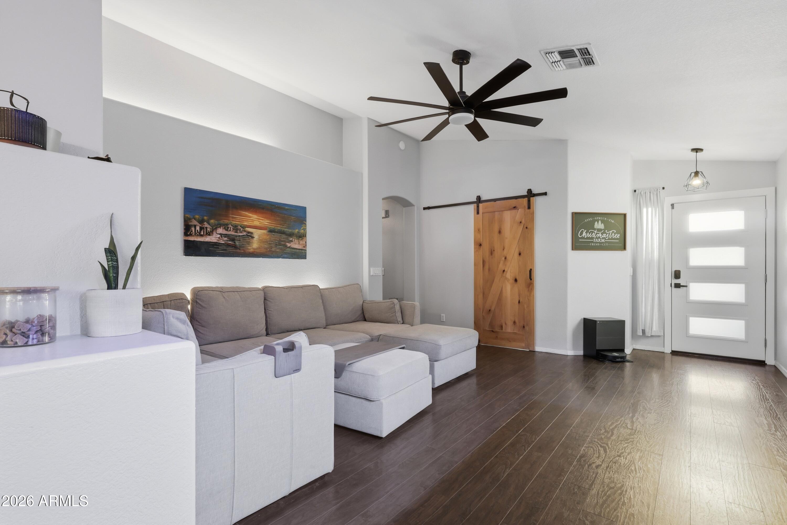 661 North Joshua Tree Lane Gilbert, AZ 85234 - Photo 4 of 47 a living room with a bed furniture and a ceiling fan
