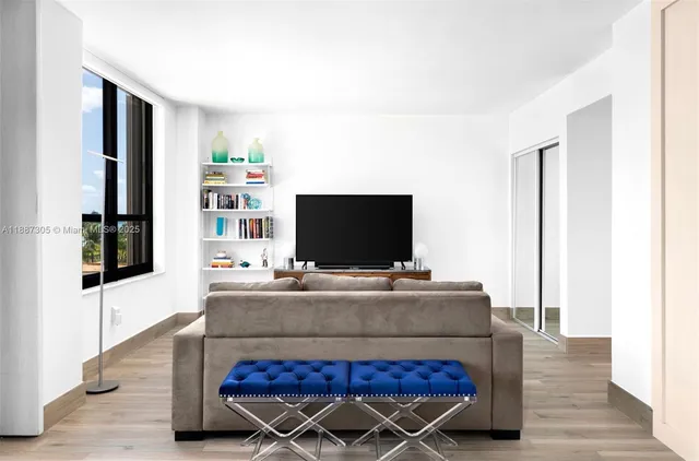 a living room with furniture and a flat screen tv