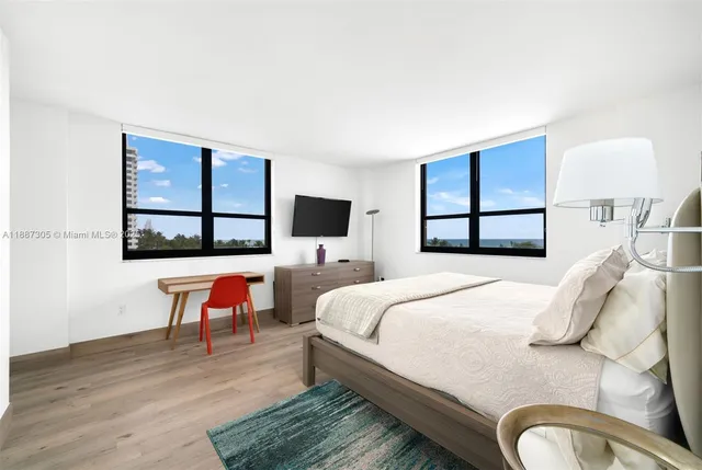 a bedroom with a bed a bookshelf and a window