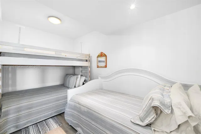 a bedroom with a bed and a night stand