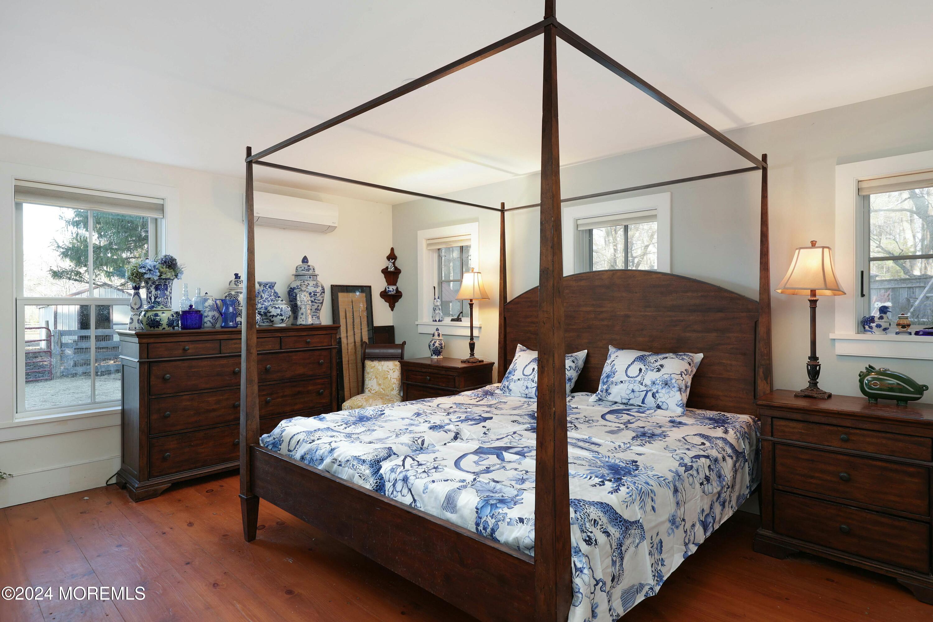 125 Sandy Ridge Road Stockton, NJ 08559 - Photo 27 of 46 a bedroom with a bed and dresser with mirror