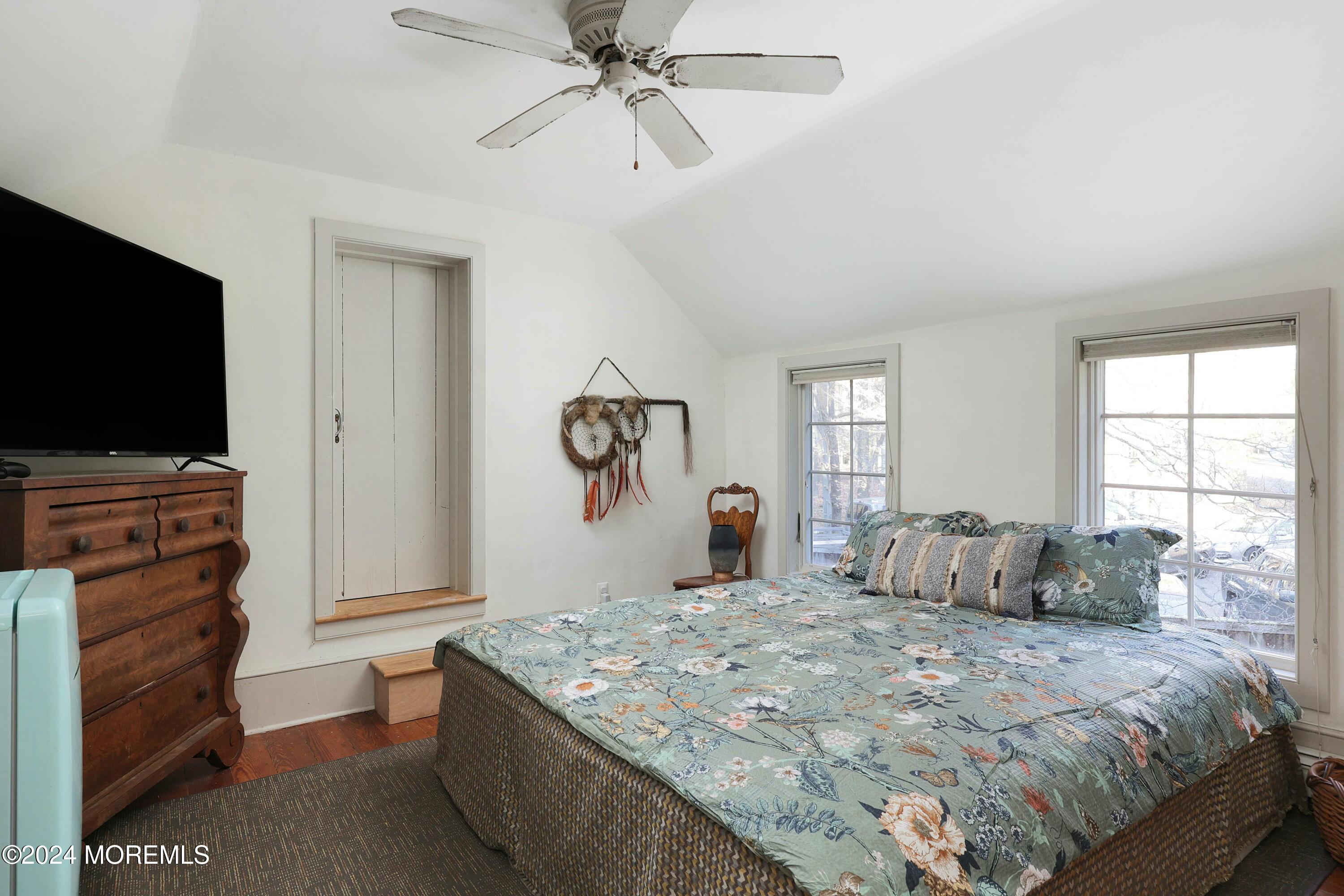 125 Sandy Ridge Road Stockton, NJ 08559 - Photo 34 of 46 a bedroom with a bed and a flat screen tv