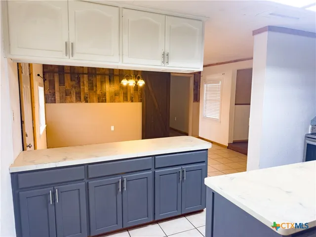 a kitchen with cabinets and a wooden floor