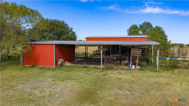 a view of a backyard with a garden and entertaining space