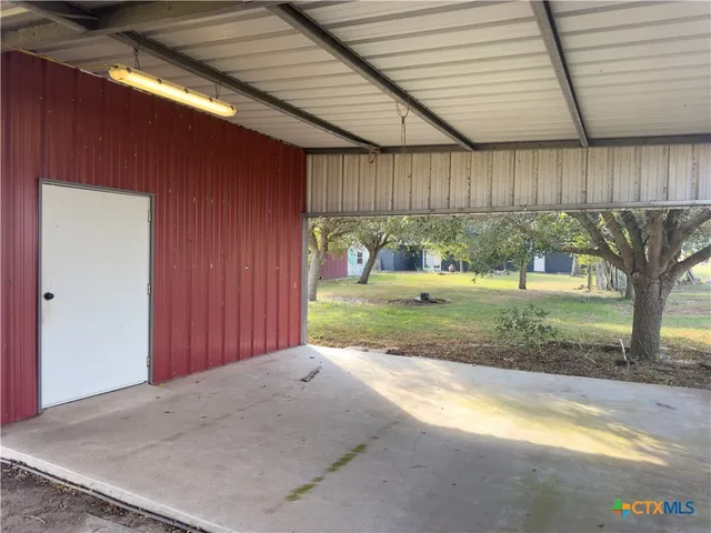 a view of backyard with wooden fence and large trees