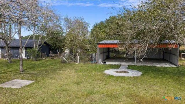 a swimming pool with outdoor seating and yard