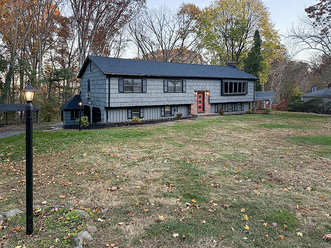 a view of a house with a yard and sitting area