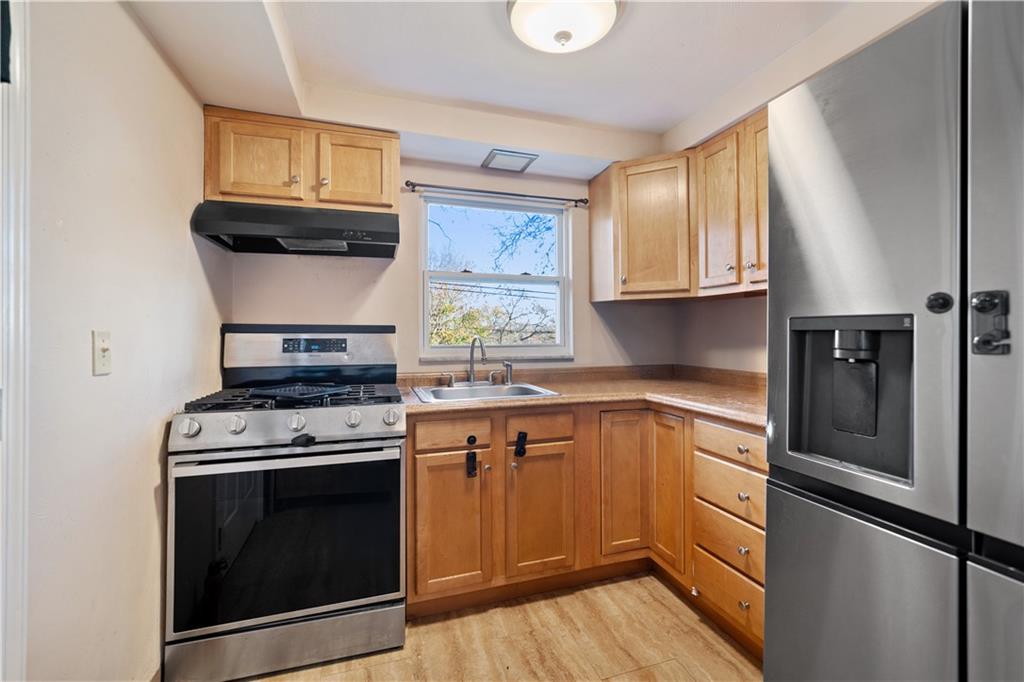227 Duncan Station Road McKeesport, PA 15135 - Photo 4 of 10 a kitchen with a stove microwave and sink
