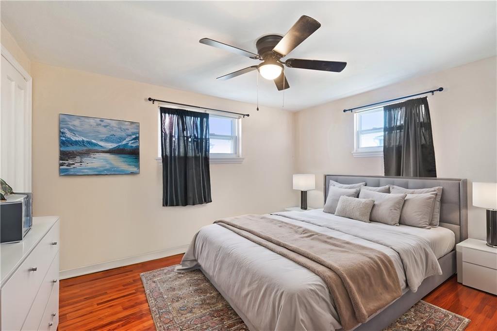 227 Duncan Station Road McKeesport, PA 15135 - Photo 5 of 10 a bedroom with a large bed and a chandelier