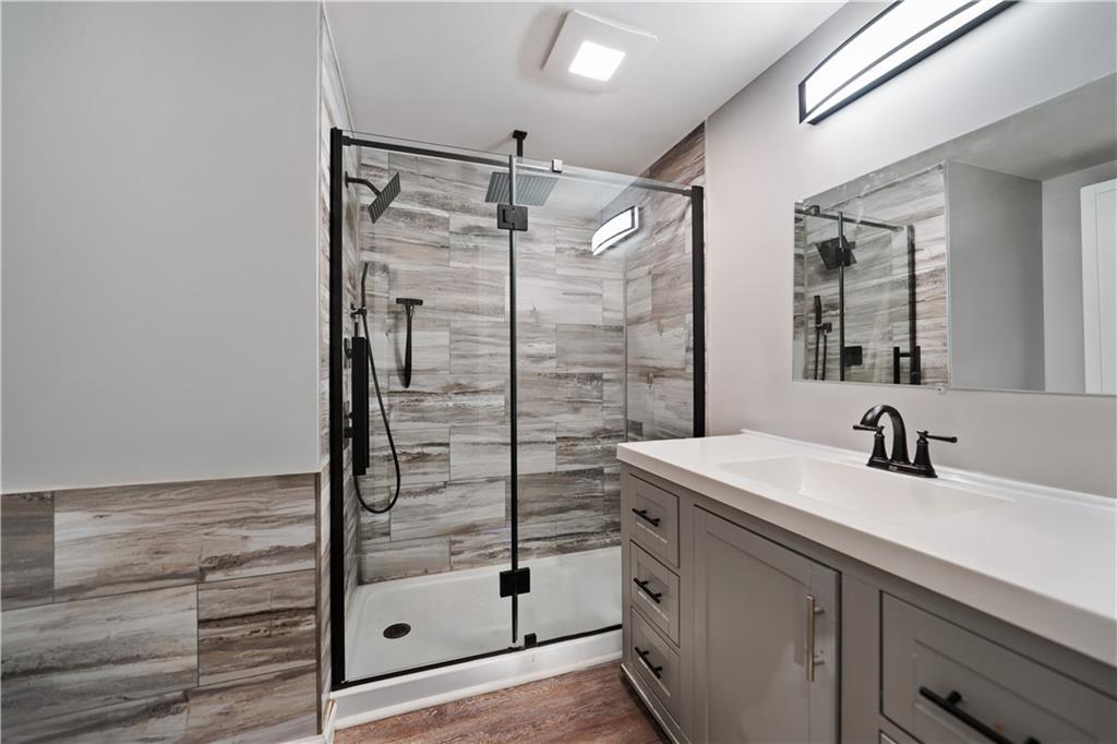 227 Duncan Station Road McKeesport, PA 15135 - Photo 7 of 10 a bathroom with a shower sink and mirror