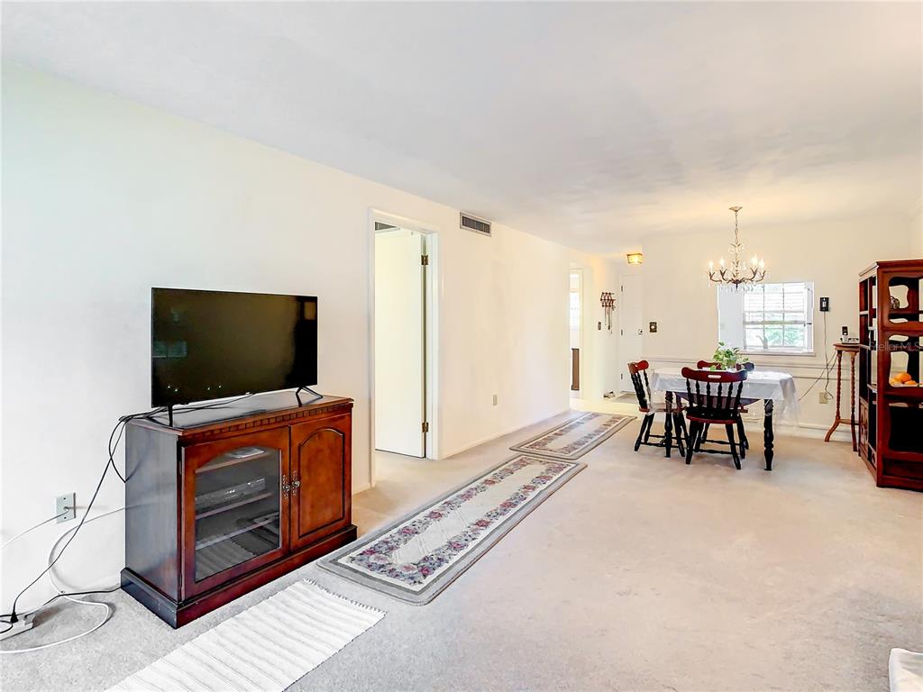 4230 Redcliff Place, Unit 4230 New Port Richey, FL 34652 - Photo 8 of 42 a living room with furniture and a flat screen tv