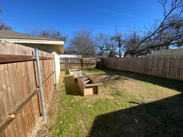 a view of a backyard with sitting area