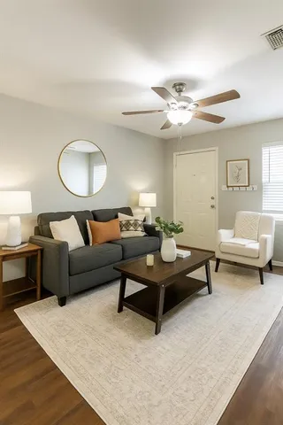 a living room with furniture and a chandelier