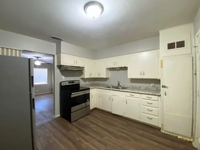 a kitchen with stainless steel appliances granite countertop a stove and a refrigerator