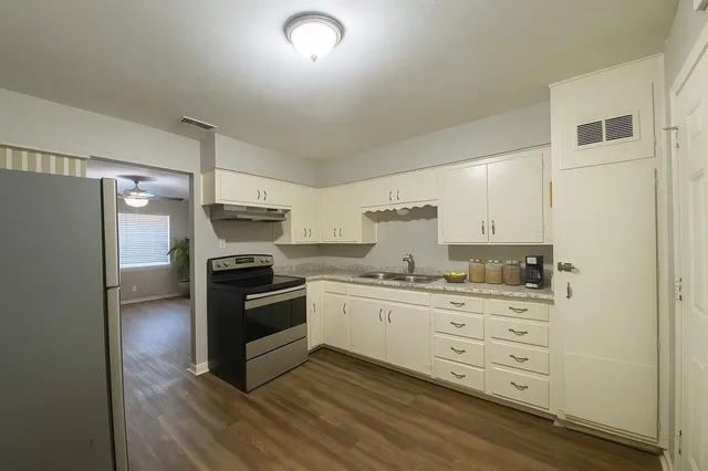 a kitchen with stainless steel appliances a stove and a refrigerator