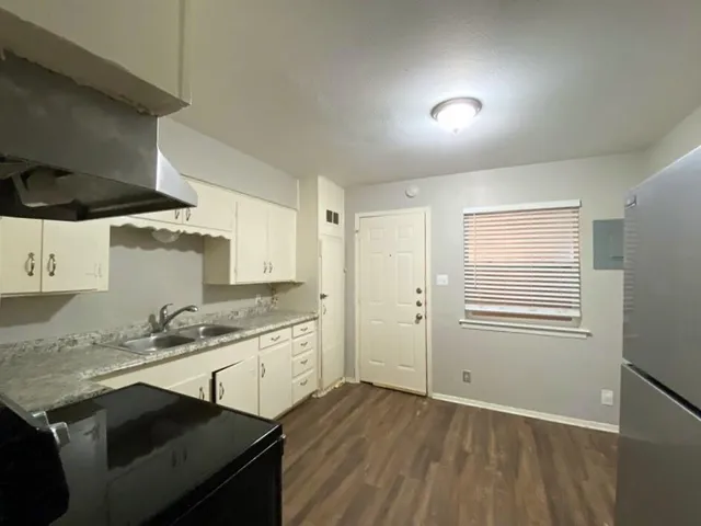 a kitchen with a sink stove and cabinets