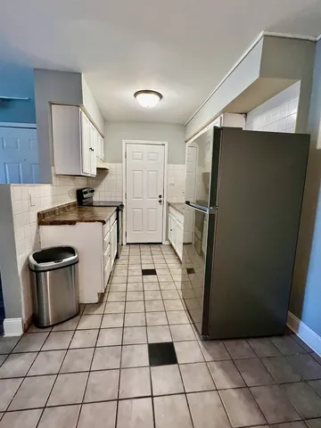 a kitchen with a stove a refrigerator and a sink
