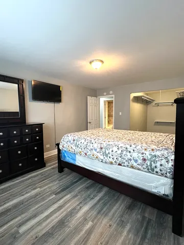 a bedroom with a bed and a television