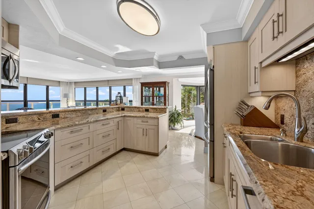 a dining room with furniture a chandelier and a rug
