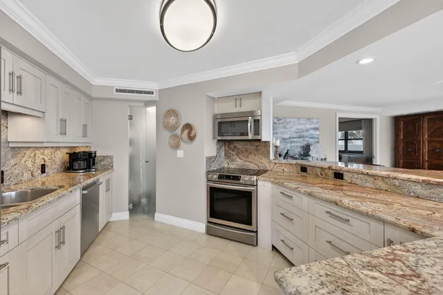 a large kitchen with a table and chairs