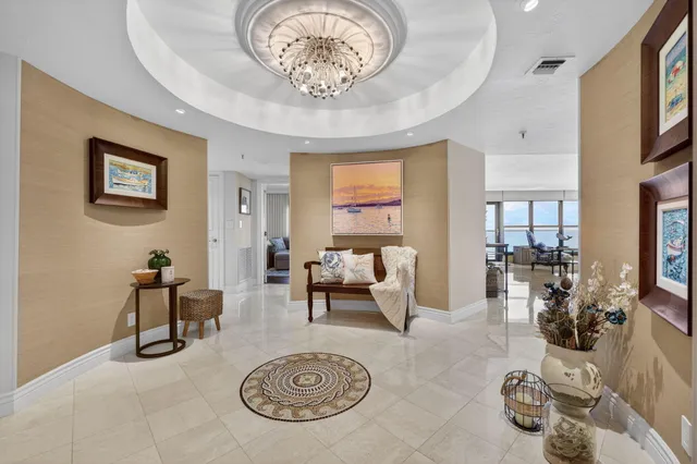 a living room with furniture a flat screen tv and floor to ceiling windows