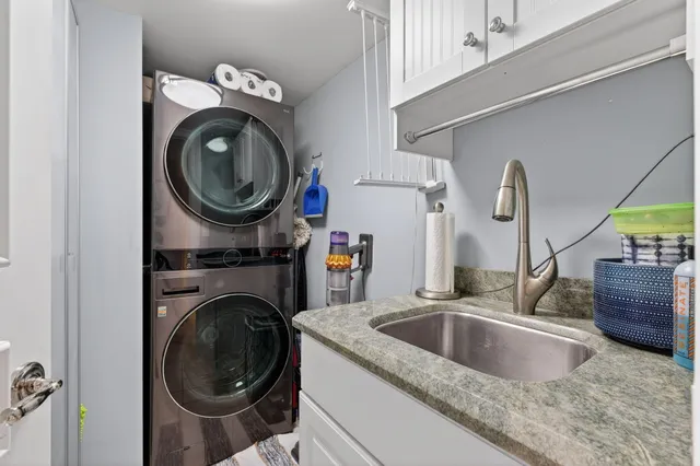 a living room with furniture a rug and a chandelier