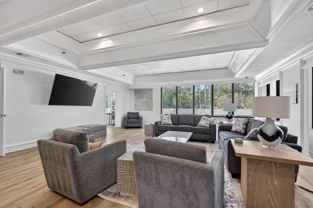 a living room with furniture and a chandelier