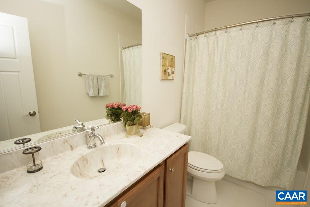 2018 Avinity Loop Charlottesville, VA 22902 - Photo 11 of 25 a bathroom with a sink a toilet and shower curtain