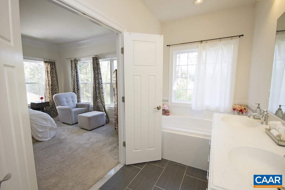 2018 Avinity Loop Charlottesville, VA 22902 - Photo 13 of 25 a bathroom with a tub sink and a mirror