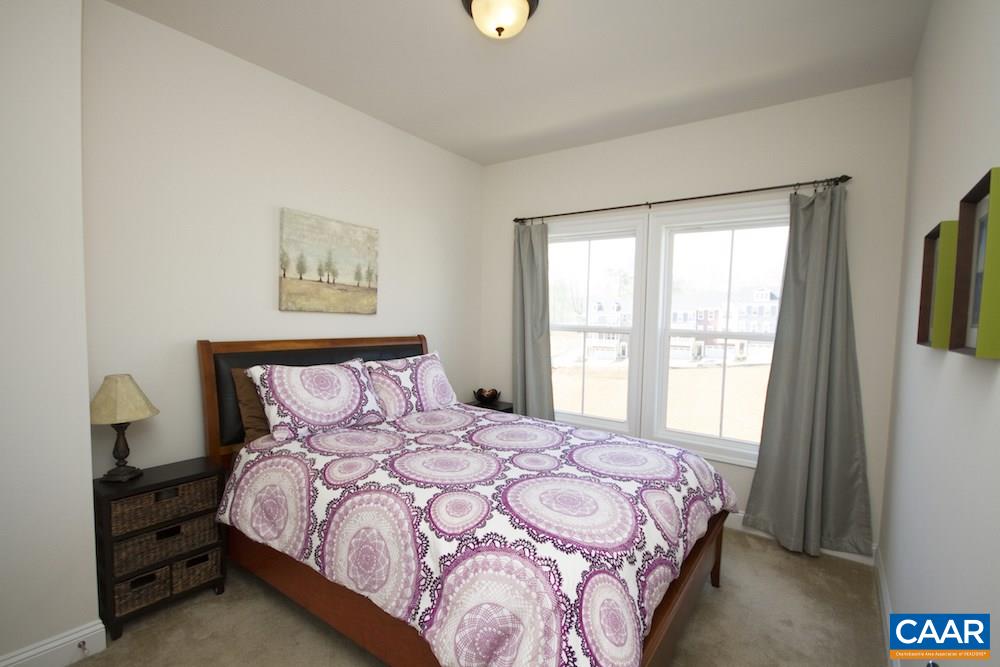 2018 Avinity Loop Charlottesville, VA 22902 - Photo 16 of 25 a bedroom with a bed a painting on the wall and a window