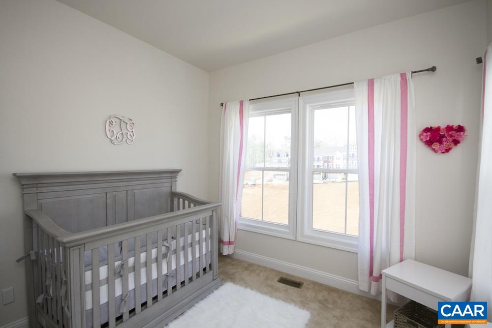 2018 Avinity Loop Charlottesville, VA 22902 - Photo 18 of 25 a bedroom with furniture and a window